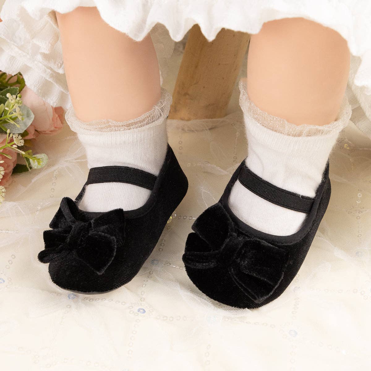 Front Bow velvety baby shoes, available in black.